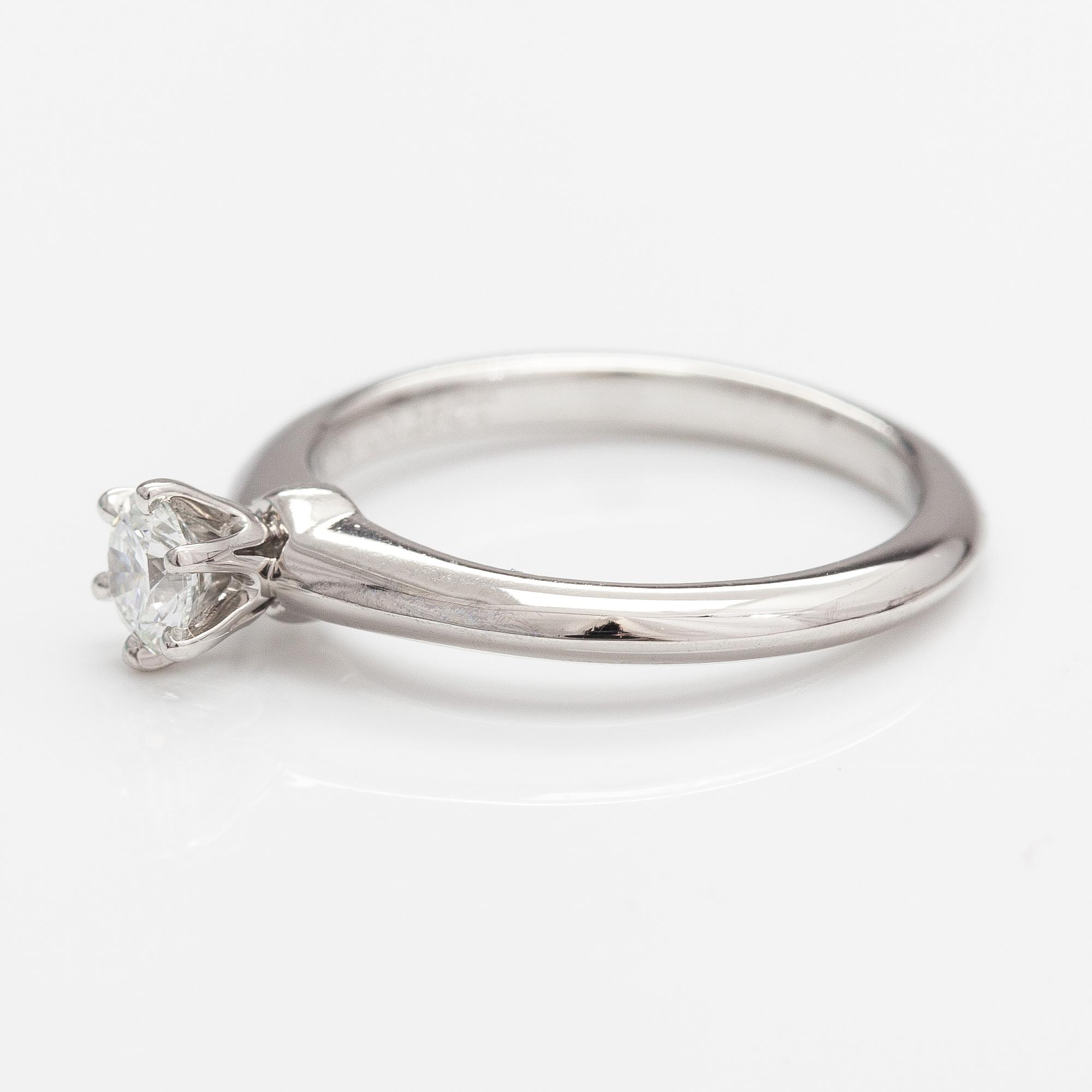 Tiffany & Co, A platinum ring with a ca. 0.26 ct diamond.