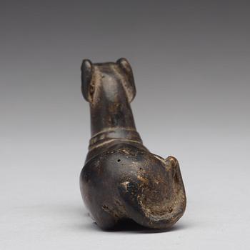 A bronze figure of a reclining dog, Ming dynasty (1368-1644).