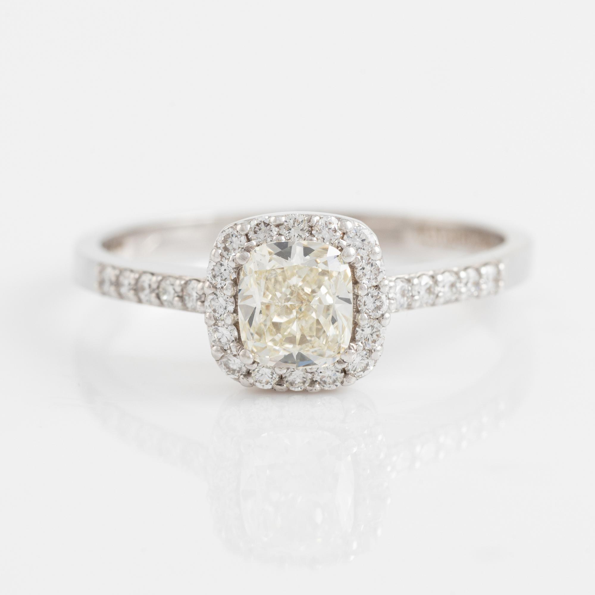Cushion cut diamond and brilliant cut diamond ring.