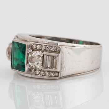 An 18K white gold WA Bolin ring set with a faceted emerald and old-, eight- and baguette-cut diamonds.