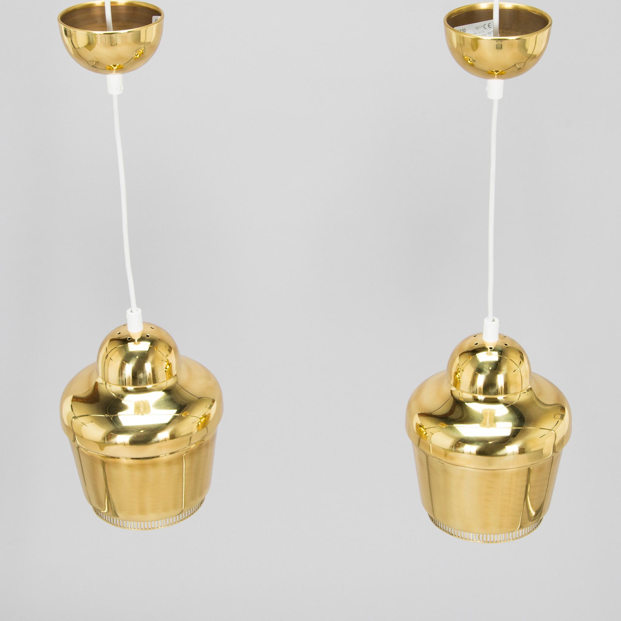 Alvar Aalto, A pair of  A 330, 'Golden Bell' pendant lights A330 for Artek, 2000s.