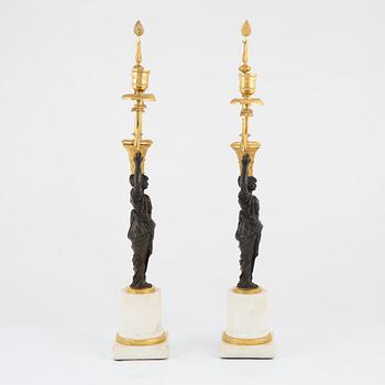 A pair of French Louis XVI ormolu, marble, and patinated bronze two-branch candelabra, late 18th century.
