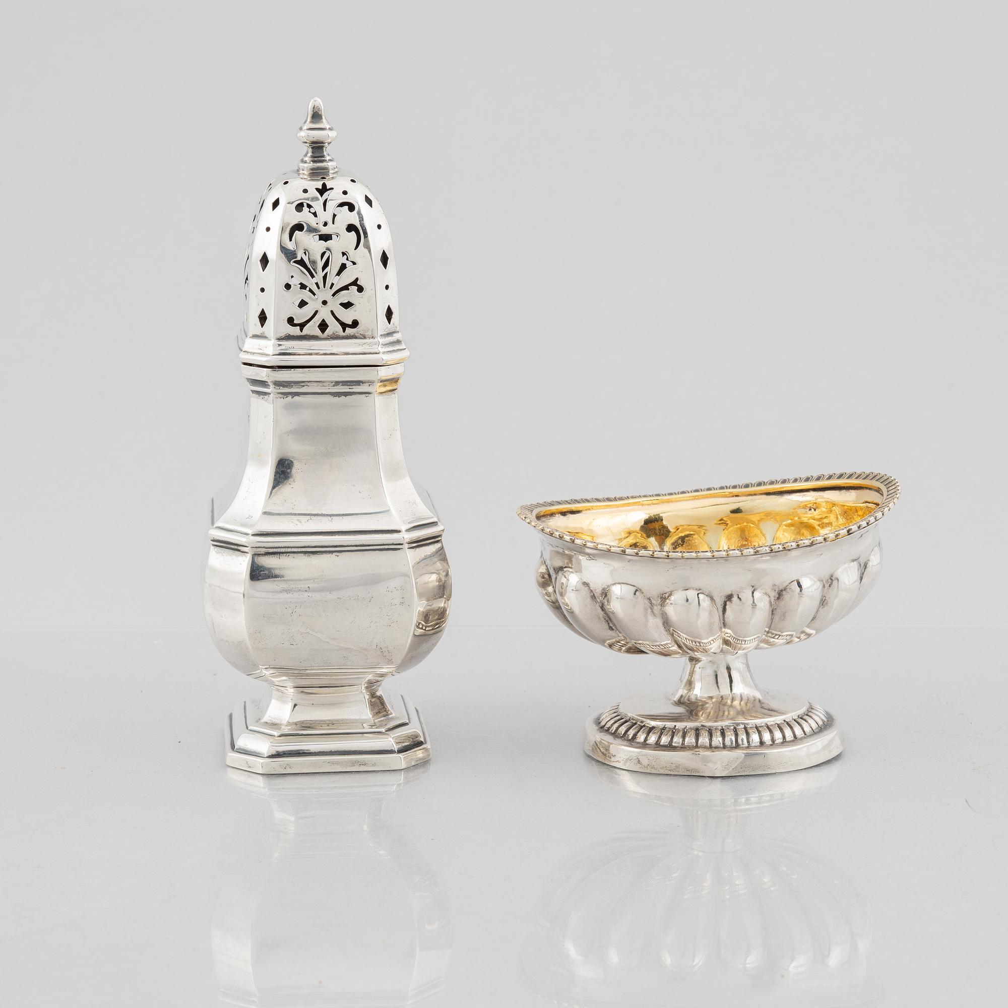 A silver sugar caster from E. S. Barnsley & Co, Birmingham,  1914, and a silver salt cellar with indistinct marks.