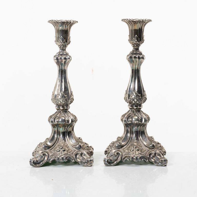 A pair of rococo-style silver candle sticks, early 20th century.