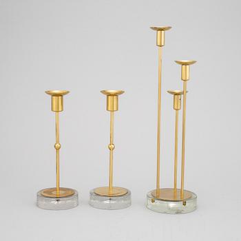 Gunnar Ander, a set of three brass and glass candlesticks from Ystad Metall.