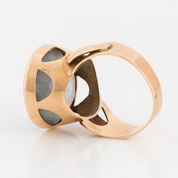 A 14K gold and synthetic blue spinel ring.