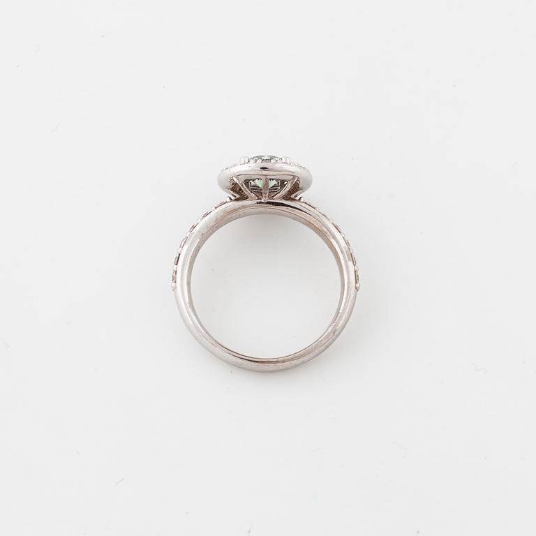 A treated green diamond and briliant cut diamonds.