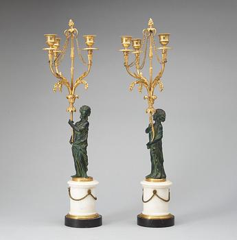 A pair of Louis XVI 18th century gilt and patinated bronze and marble three-light candelabra.