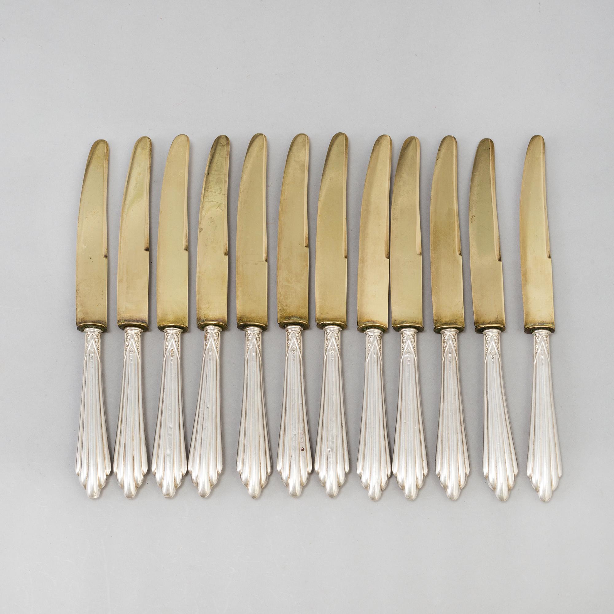A set of twelve parcel-gilt silver fruite knives from the late 19th century.