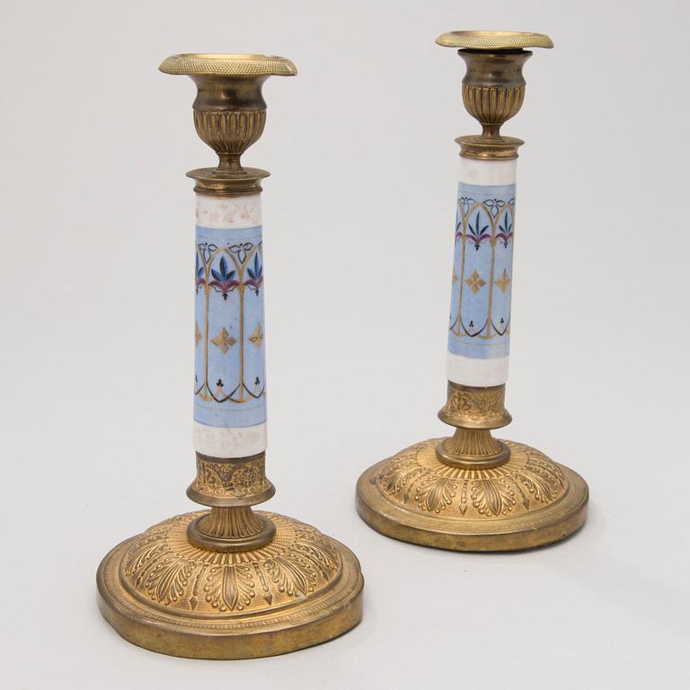 A PAIR OF RUSSIAN CANDLESTICKS, bronze and porcelain, first half of the 19th century.