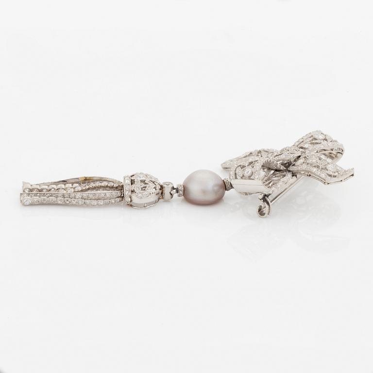 A platinum bow brooch set with old-cut diamonds with a detachable pearl and platinum pendant.