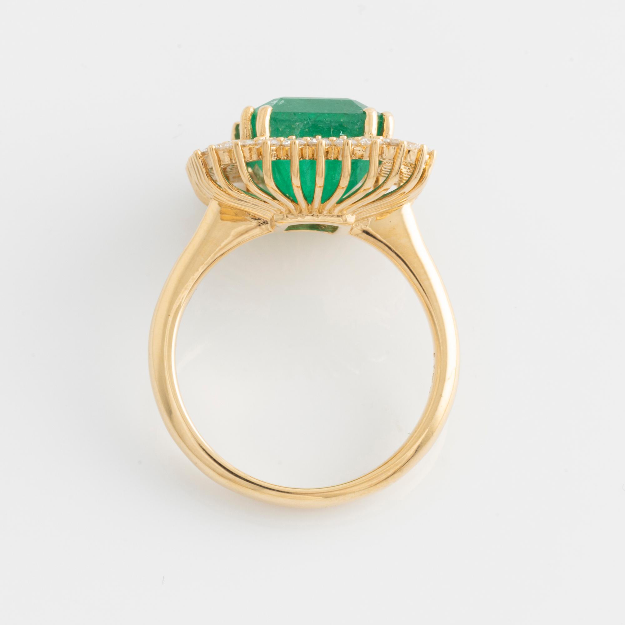 Ring with emerald-cut emerald and brilliant-cut diamonds.