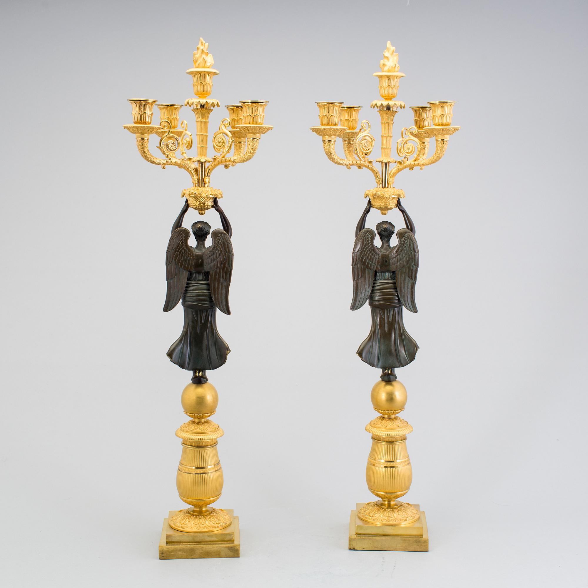 A large pair of first half of the 19th century gilt and patinated bronze five-light candelabra.