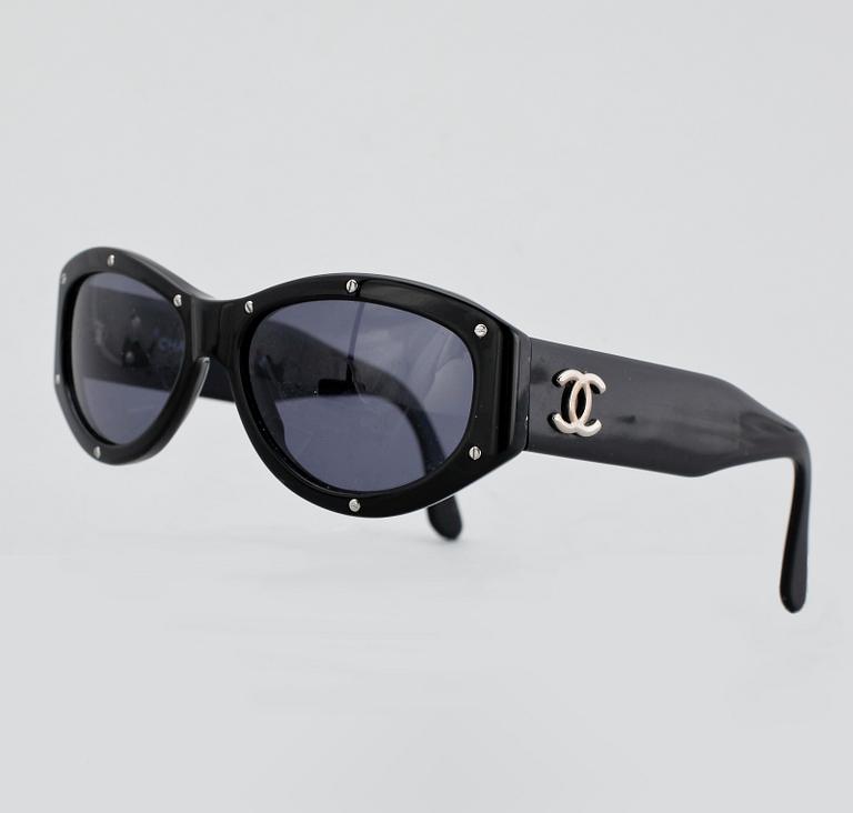A pair of sunglasses by Chanel.