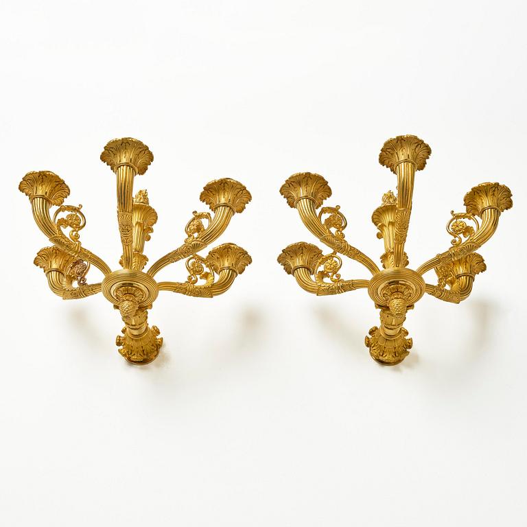 A pair of French Empire six-branch ormolu appliques, ca 1820's.