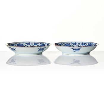 A pair of blue and white floral dishes, Qing dynasty, with Qianlong mark and of the period (1736-95).