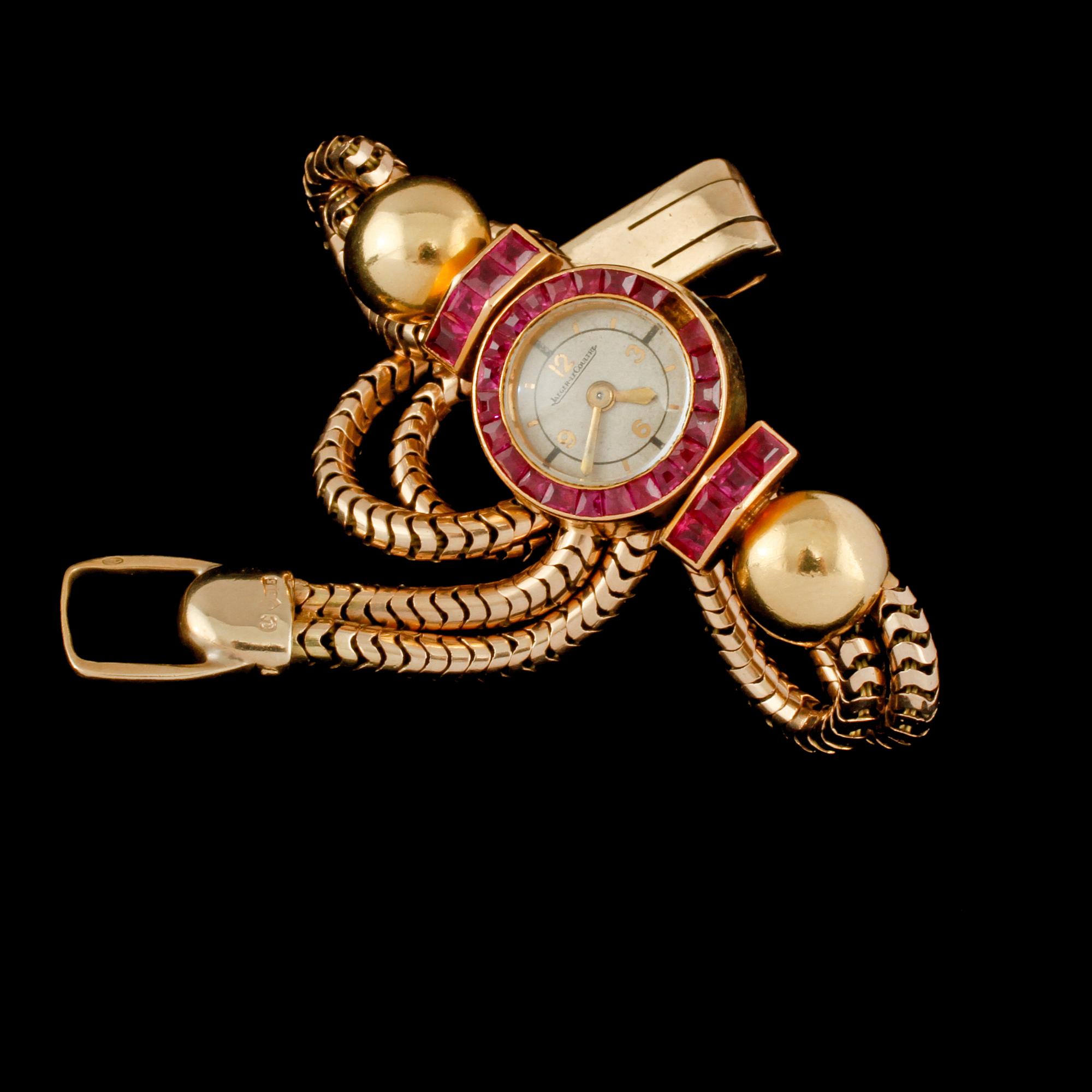 ARMBANDSUR, 18K samt 8K guld med fasettslipade rubiner, Jaeger-LeCoultre, 1900-talets första hälft.
