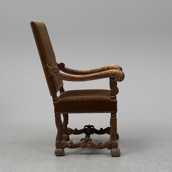 A carved baroque style armchair from around 1900.