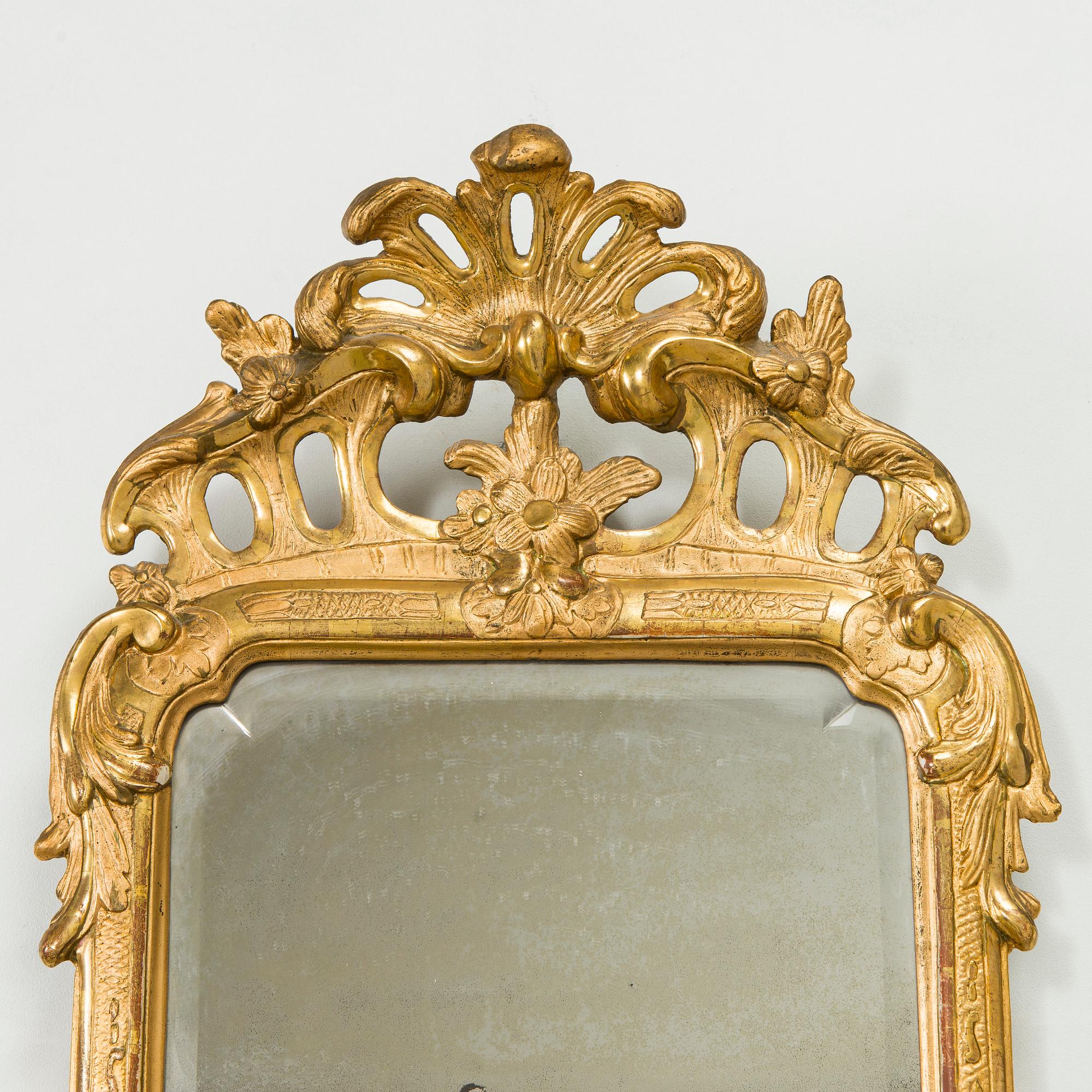 A Rococo giltwood mirror by Nils Meunier (master in Stockholm 1754-97, royal court mirror maker 1769).