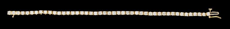 A gold and diamond tennis bracelet.