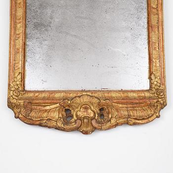 A Swedish rococo giltwood mirror in the manner of E. Göbel, Stockholm, later part 18th century.