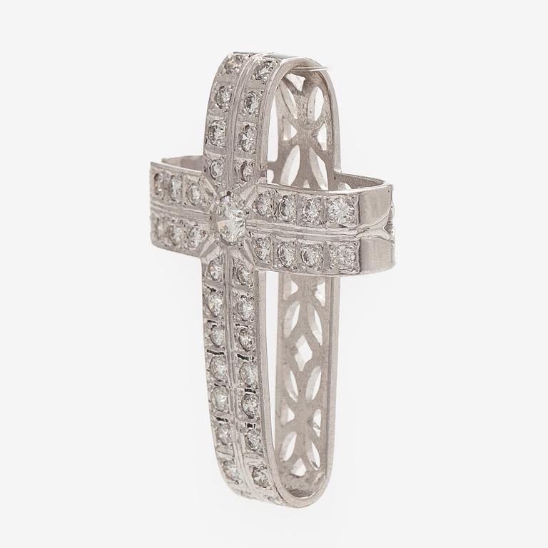 An 18K white gold cross pendant with diamonds.