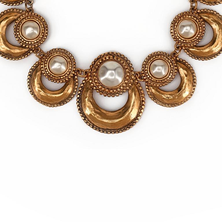 CHANEL, a gold colored metal necklace with white decorative pearls.