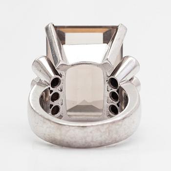 An 18K whitegold ring with an emeraldcut smokey quartz and diamonds approx 0.70 ct in total, Kultala, Helsinki 2008.