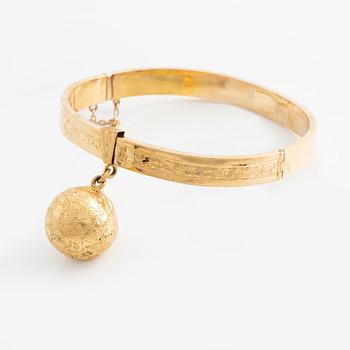 Armband 18K guld med berlock i form av jordglob.
