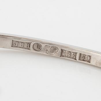 A bangle 18K white gold with aquamarine and two round brilliant-cut diamonds.