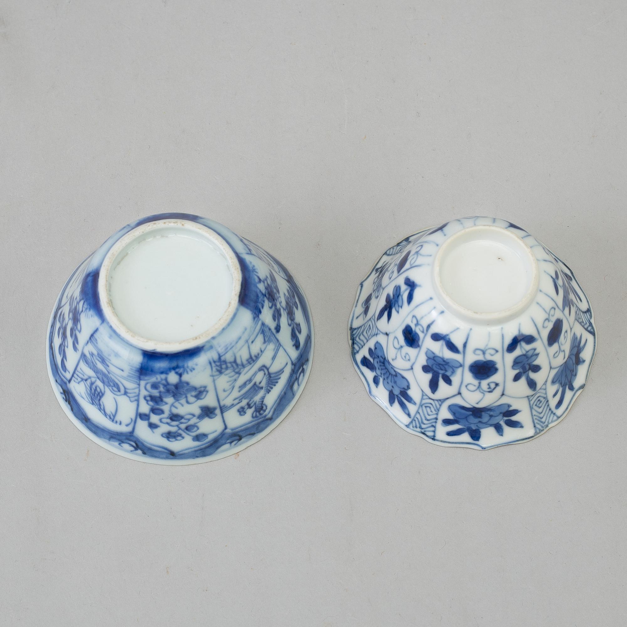 Two blue and white dishes and two cups with dishes, Qing dynasty, Qianlong (1736-95) and Kangxi (1662-1722).