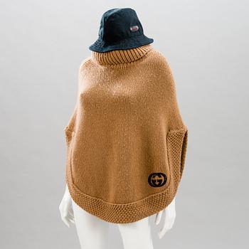 GUCCI, CAMEL HAIR PONCHO AND A HAT.