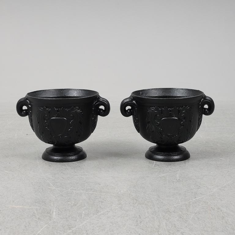 An early 20th Century pair of cast iron pots.