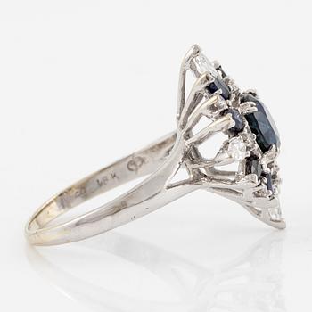 Ring 18K white gold with dark sapphires, pear-shaped and brilliant-cut diamonds.