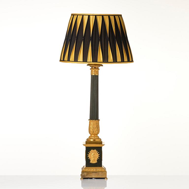 A French late Empire ormolu and patinated bronze lamp, first part 19th century.