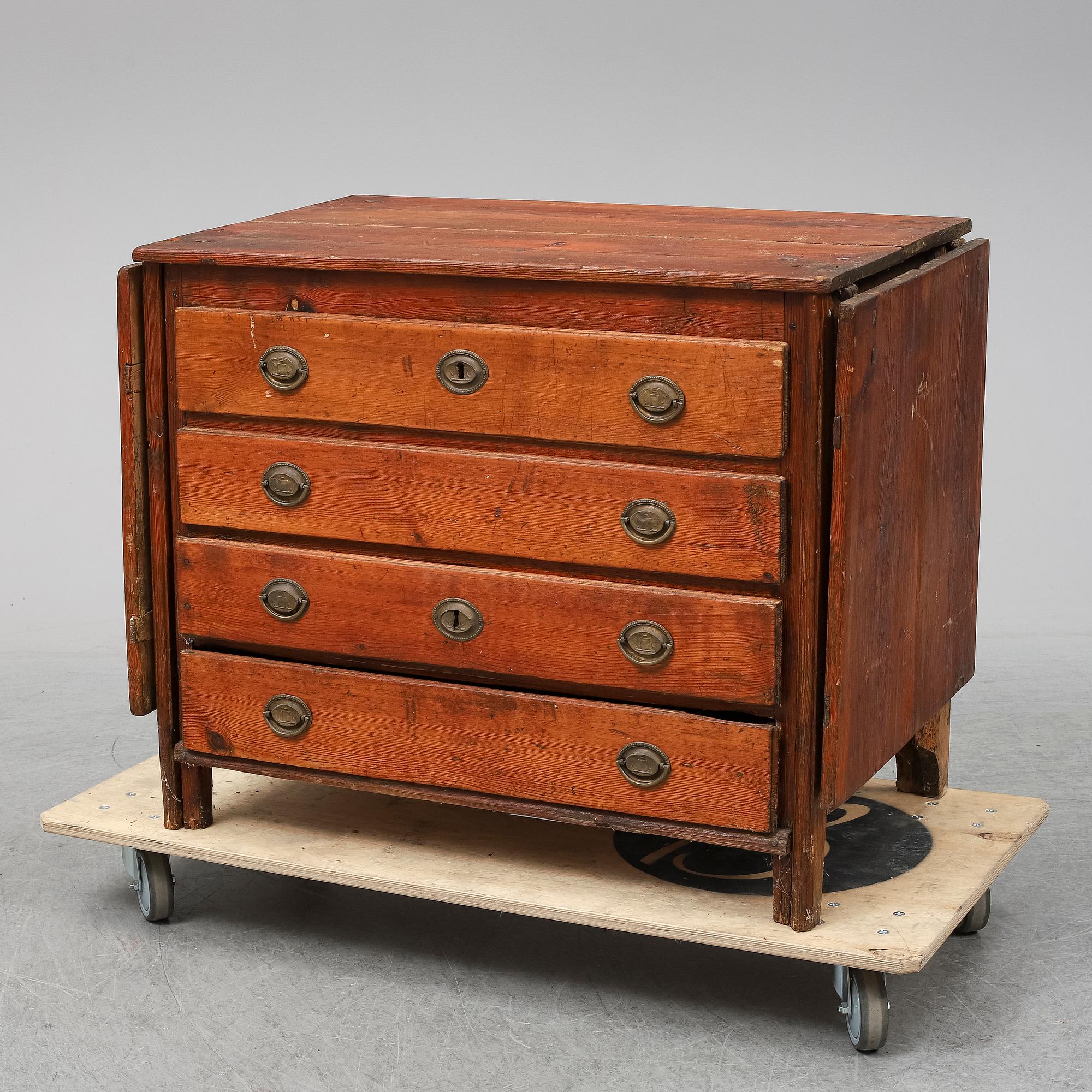 A 19th Century chest of drawers with a table top.