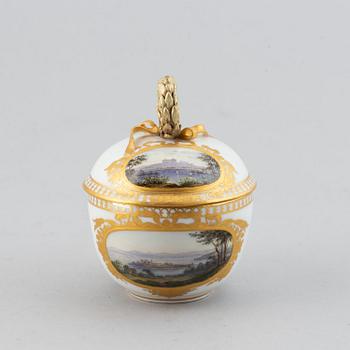 A 19th century Meissen miniature lidded porcelain cup decorated with views of Mainau.