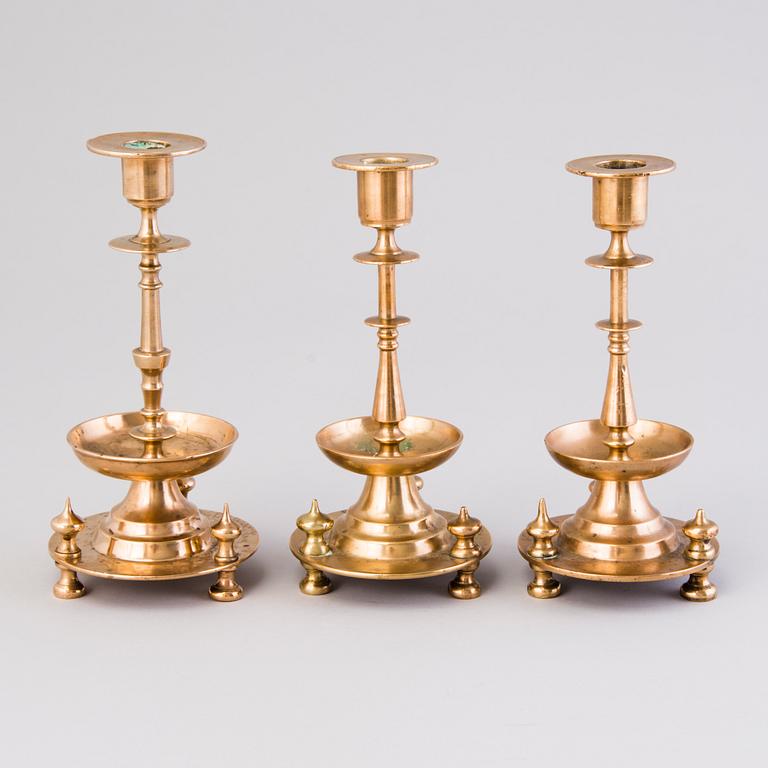 Three Russian brass candlesticks from the end of the 19th and the early 20th Century.