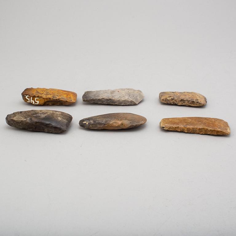 Six neolithic flint axes.