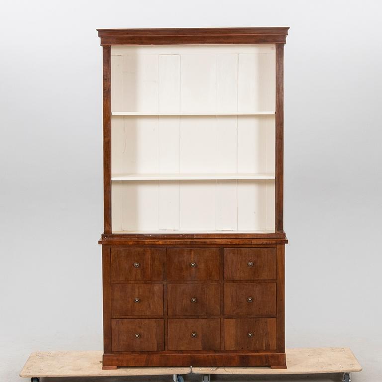 A stained walnut cabinet from the first half of the 20th century.