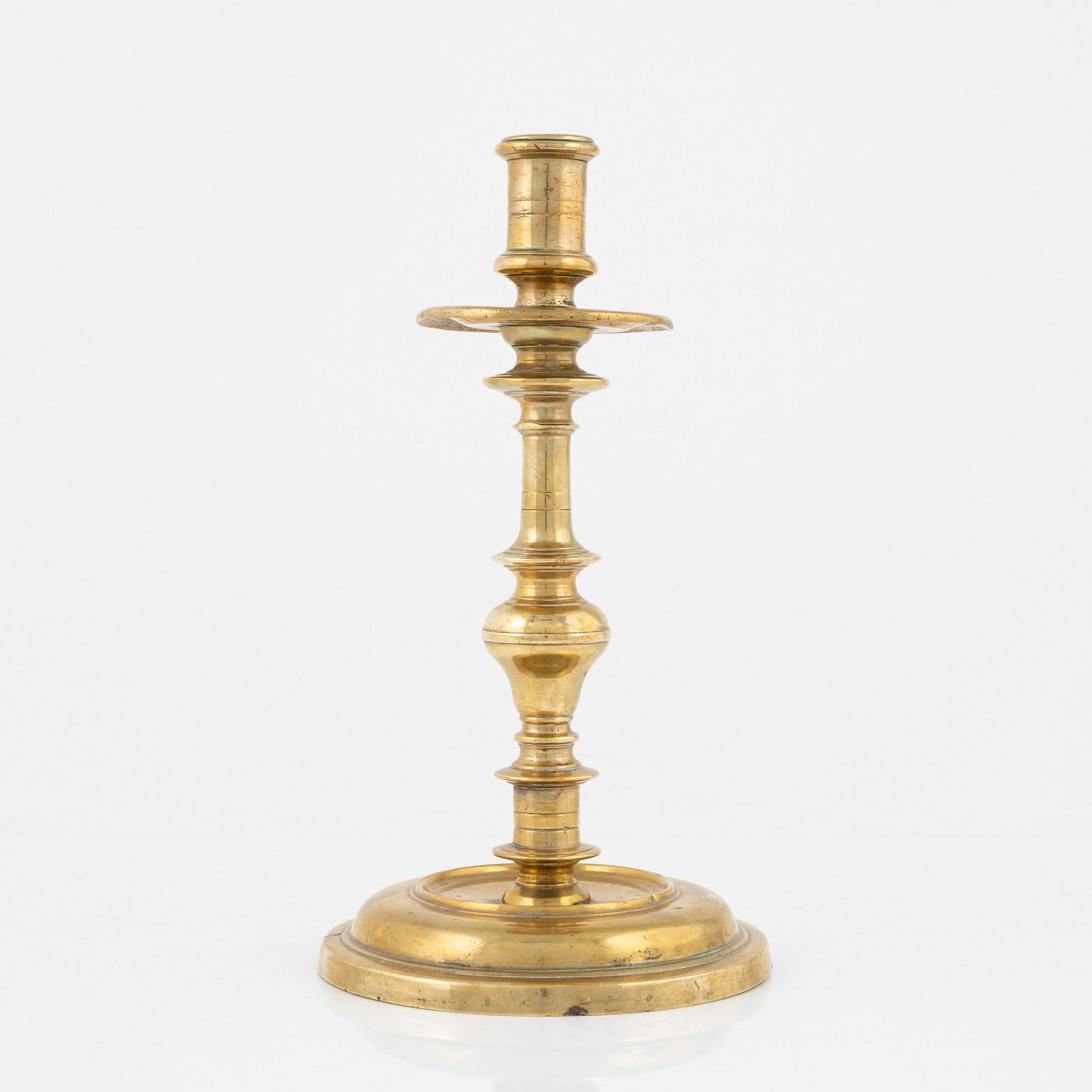 A brass candlestick, 18th century.