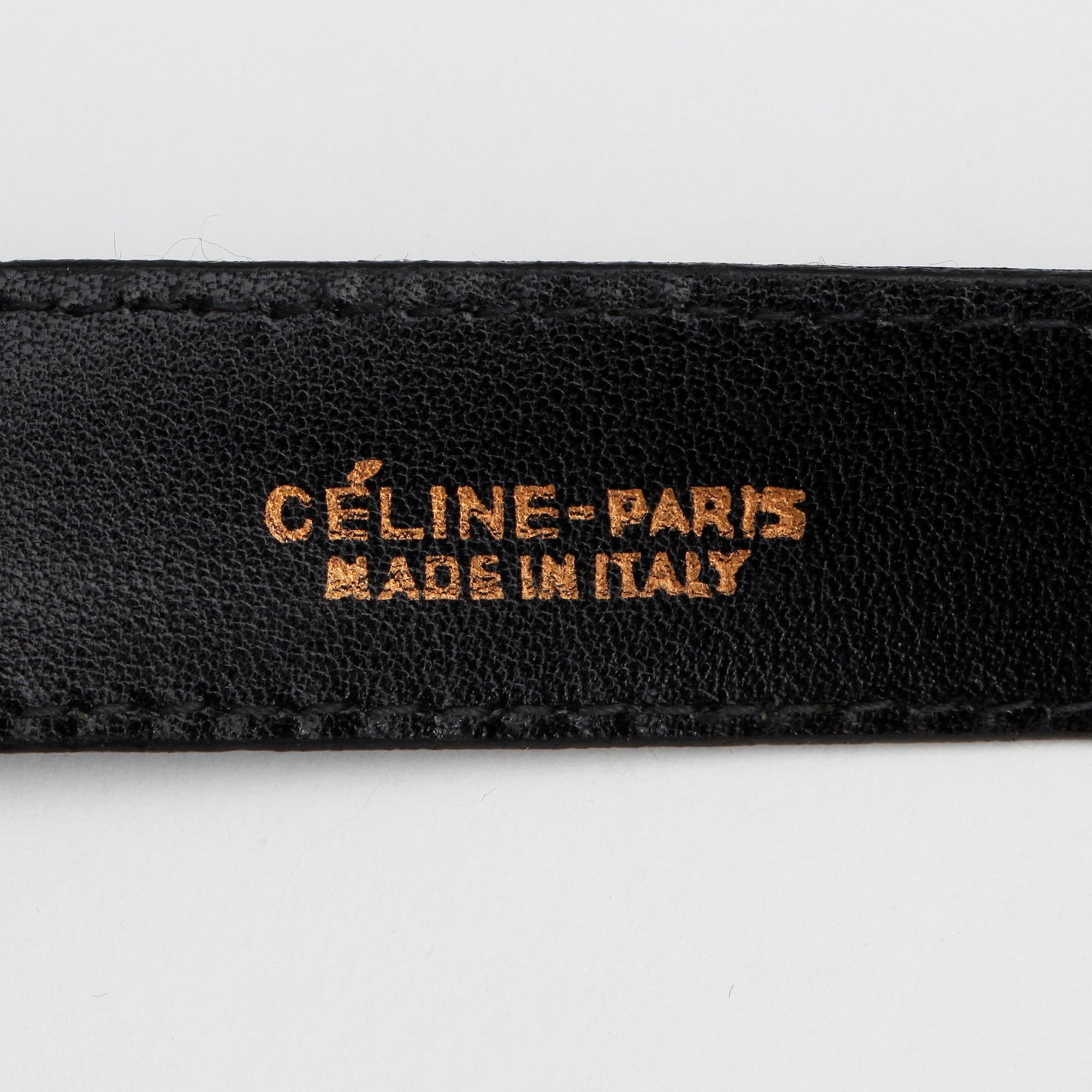 CÉLINE, a black lacquer leather belt.