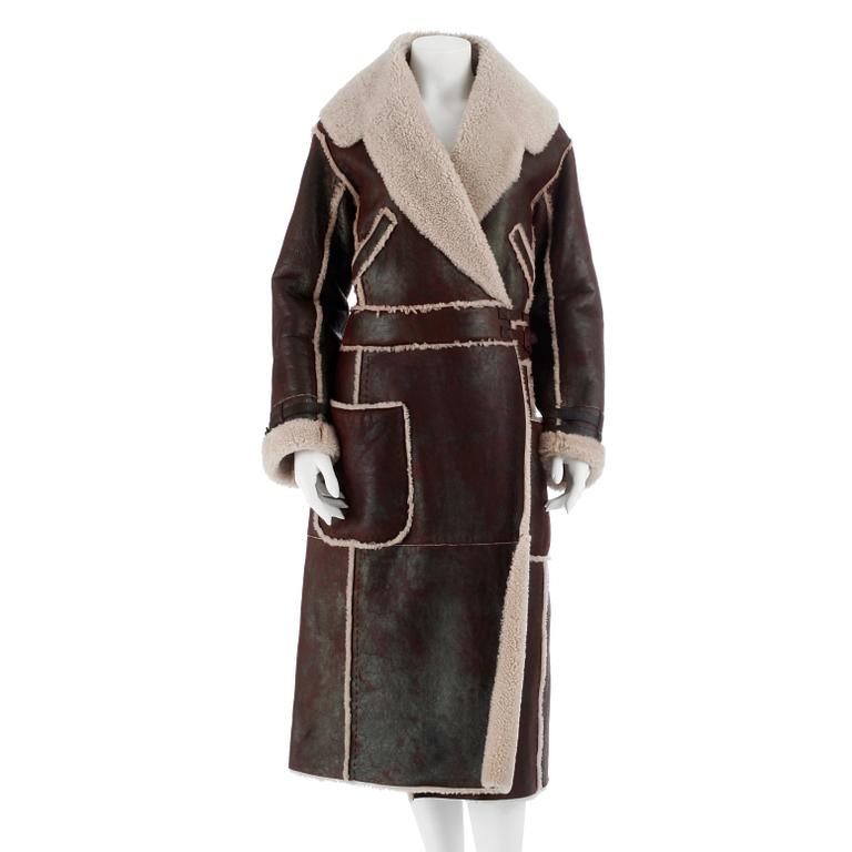 ALEXANDER MCQUEEN, a brown leather and shearlingfur coat. Size 42.