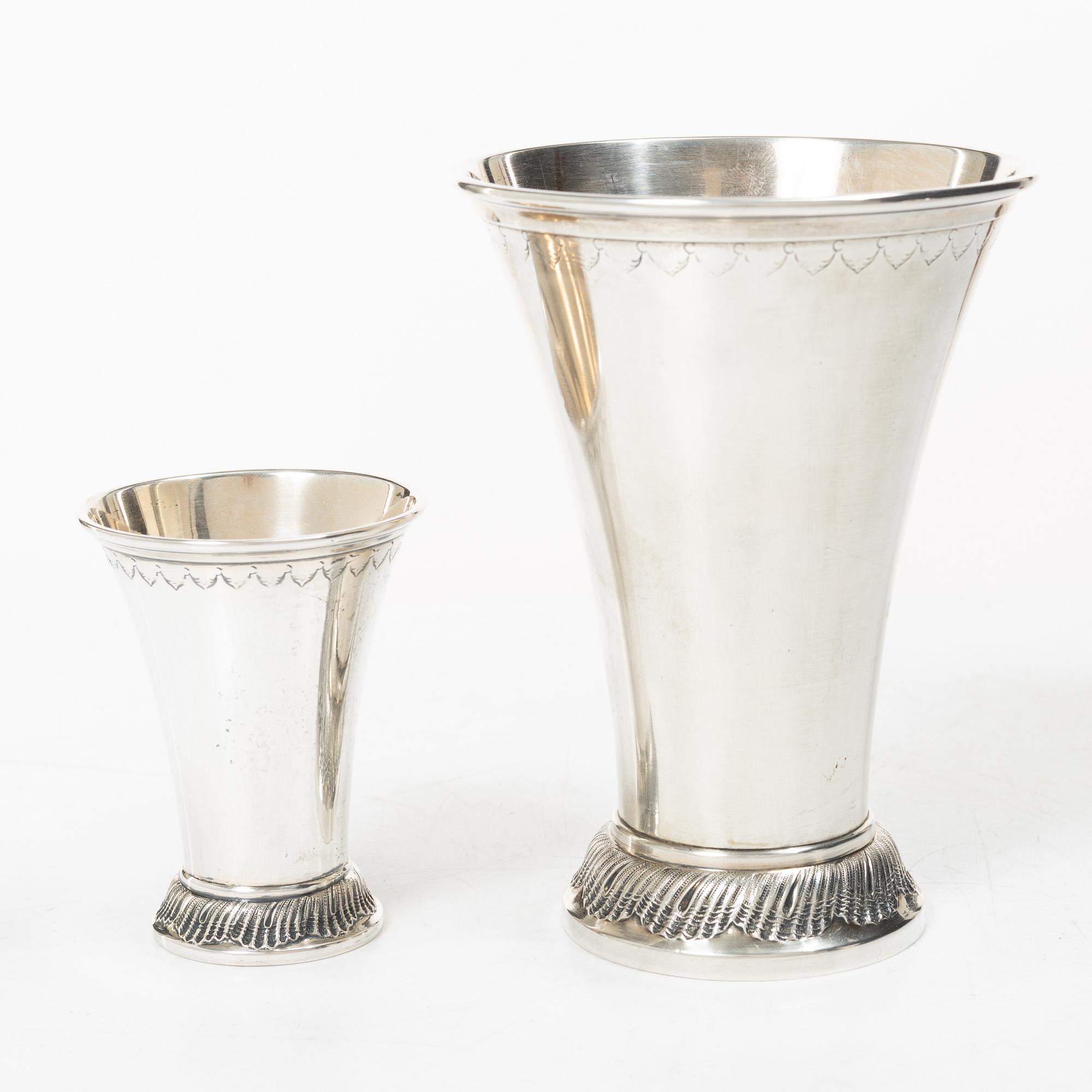 Two silver beakers and a bowl,