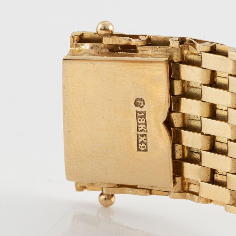 Bracelet in 18K gold with white stones.