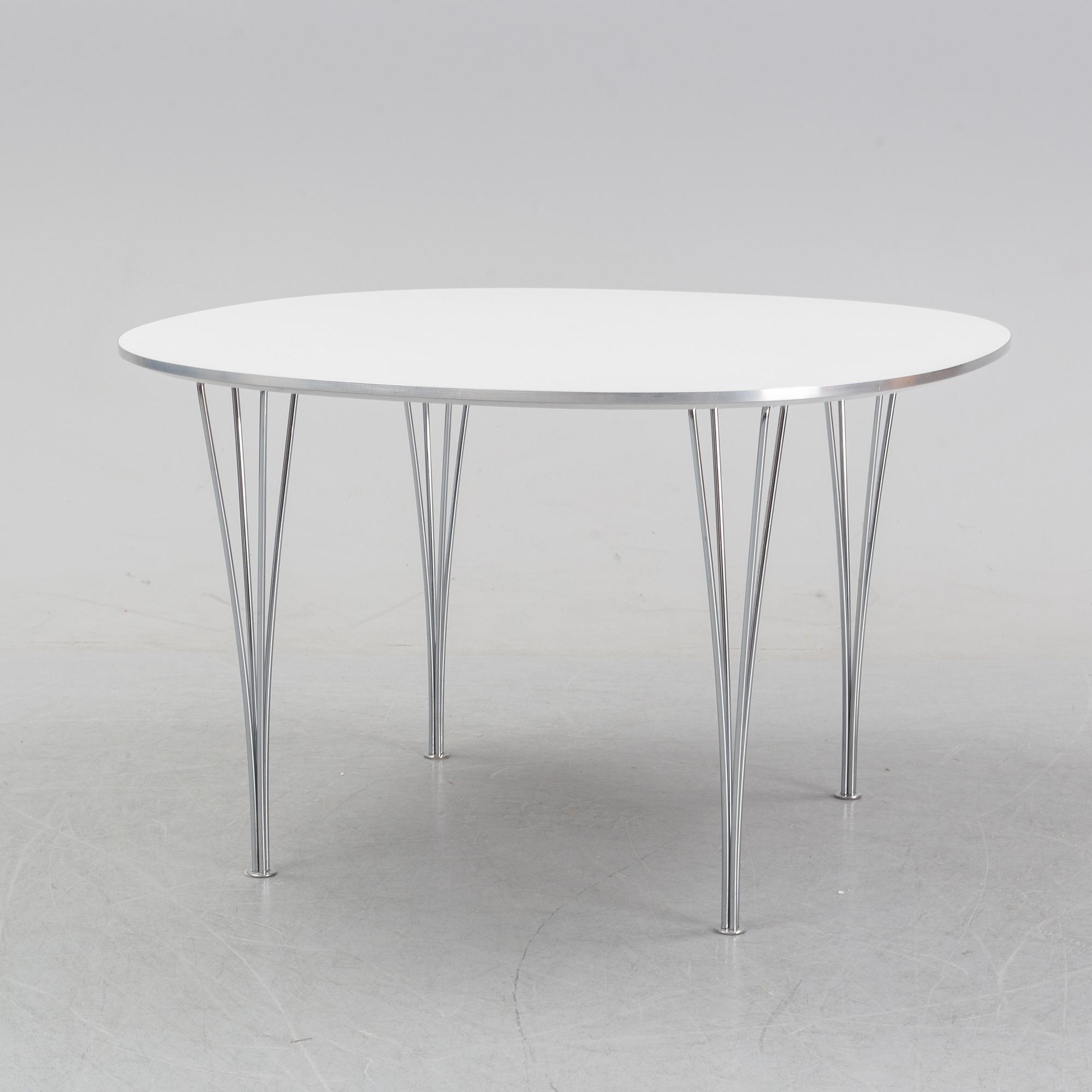 A 'Supercircular' table by Bruno Mathsson & Piet Hein for Fritz Hansen, dated 1985.