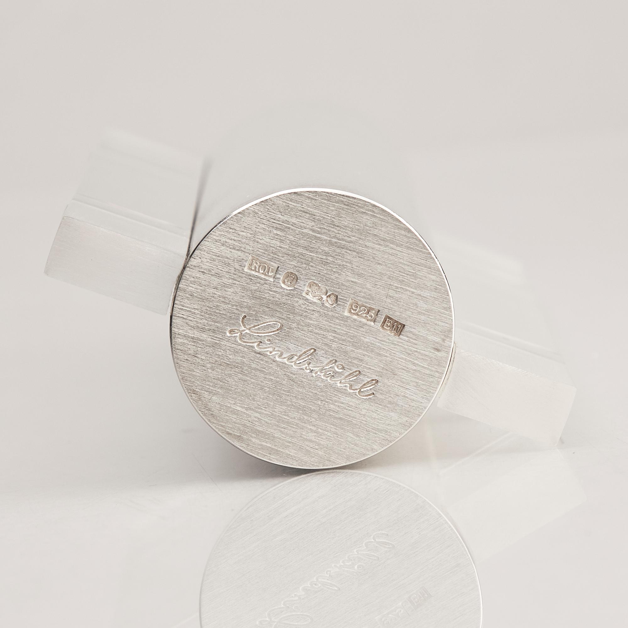 A sterling silver and acrylic bottle with lid, mark of Rolf Lindståhl, Stockholm 2003.