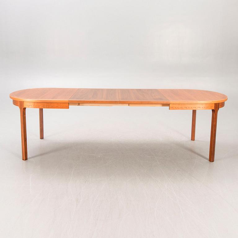 A Nils Jonsson teak and walnut 1960s dining table.