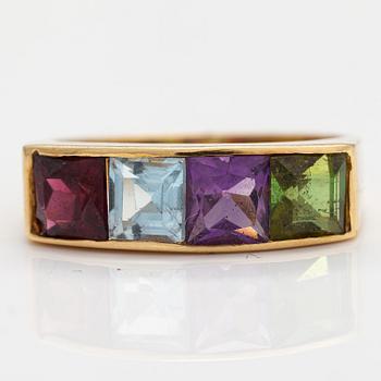 An 18K gold ring with an amethyst, garnet, topaz and peridote.