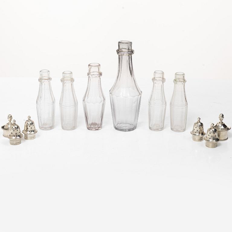 Parts for a table centrepiece, six glass bottles, and seven lids in silver, marked Pehr Zethelius, Stockholm 1807.